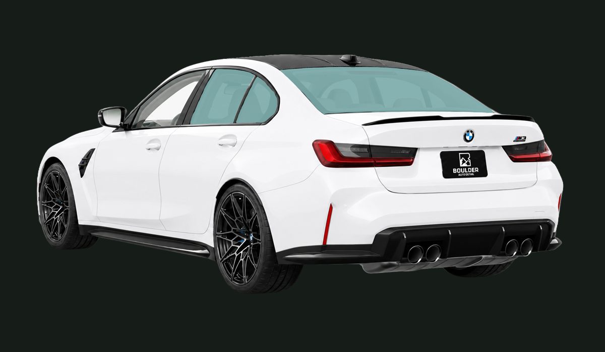 White BMW sedan, rear three-quarter view, on a dark background
